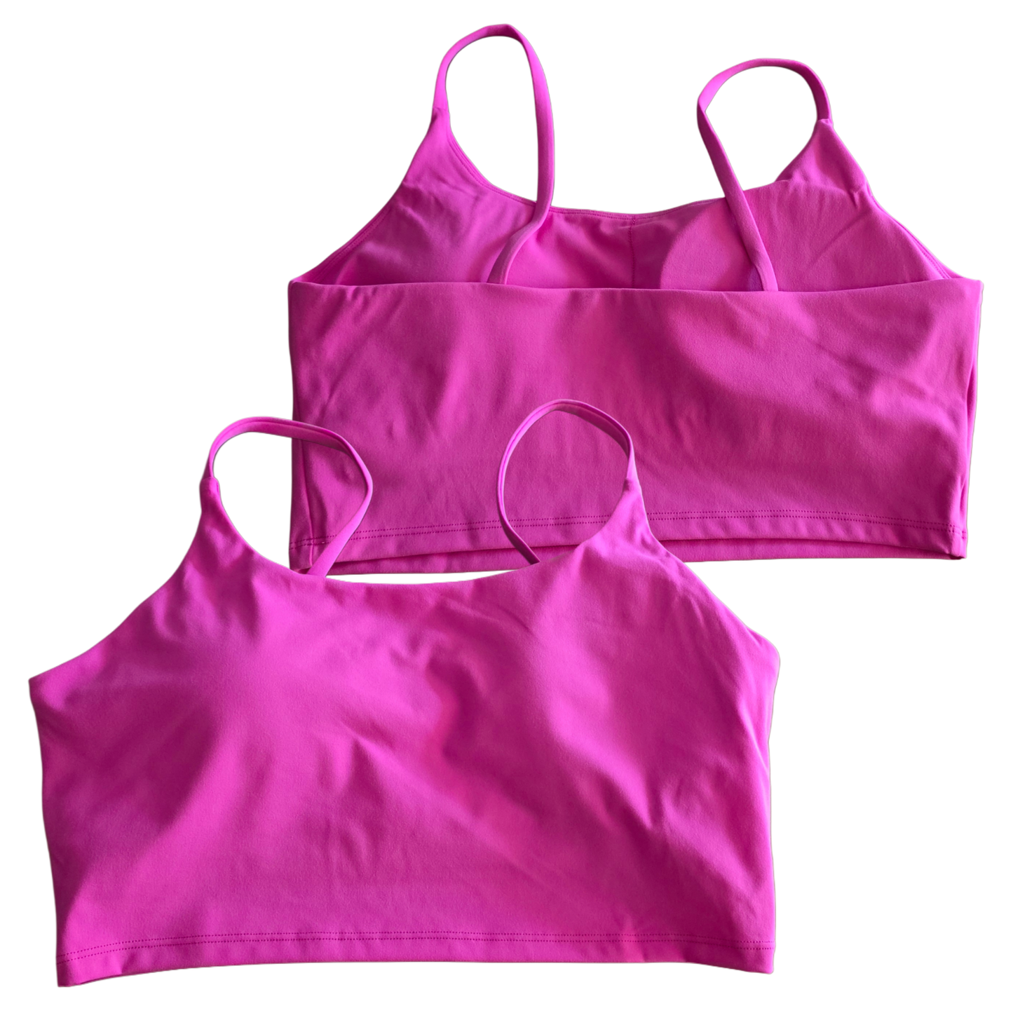 Two pink crop tops on a white background