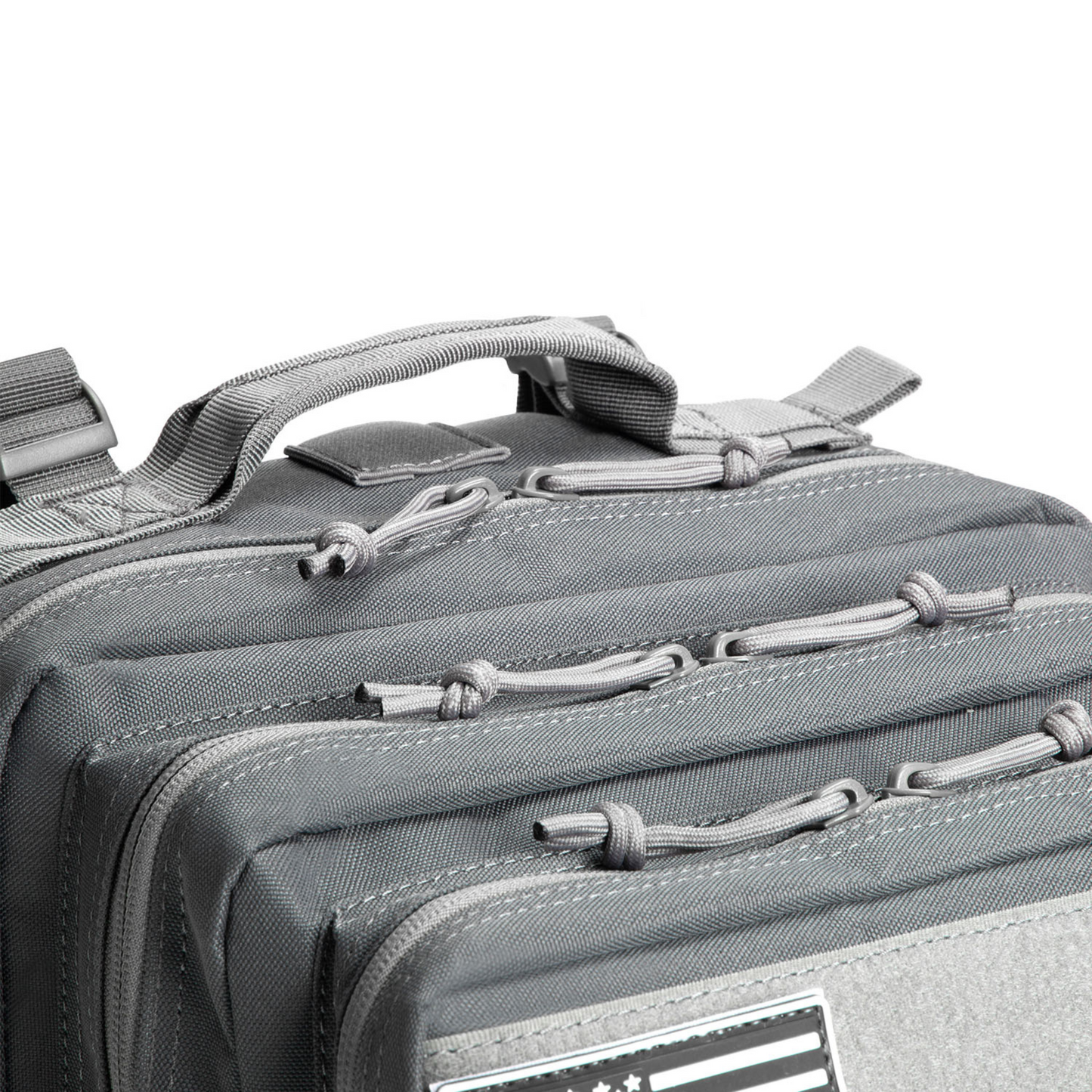 Close-up of a gray tactical bag with zippers and straps on a white background
