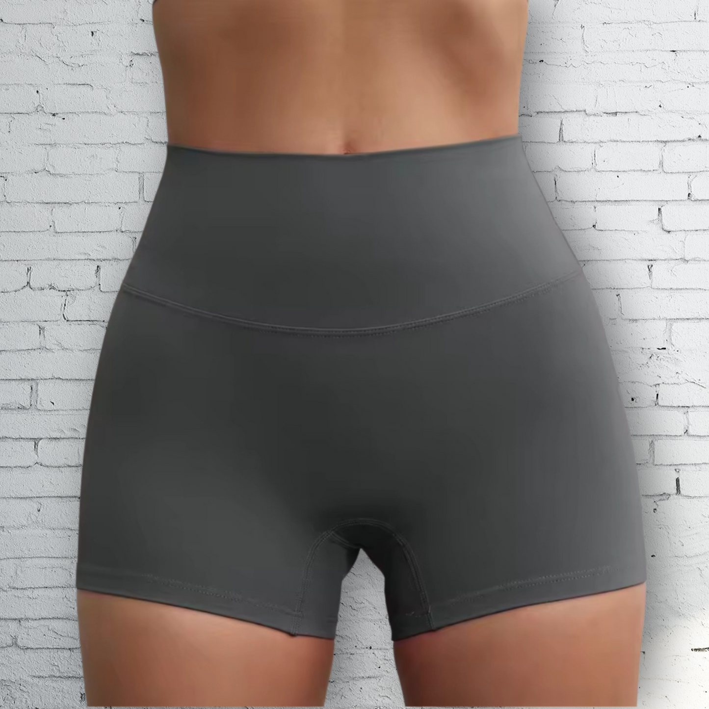 A pair of high-waisted, graphite gray workout shorts with a 3-inch inseam.