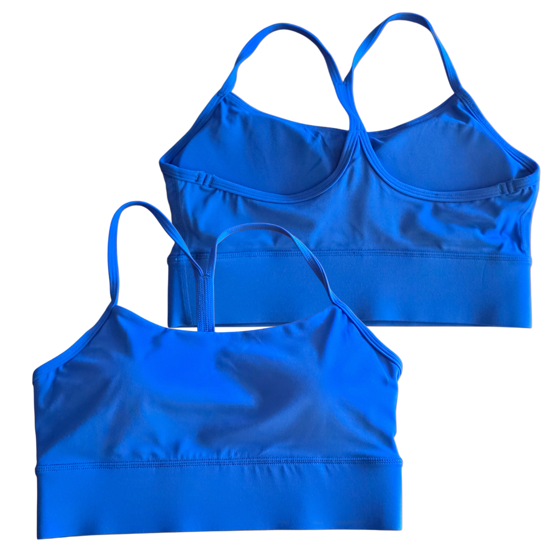 Two blue sports bras on a white background