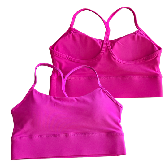 Two pink sports bras on a white background