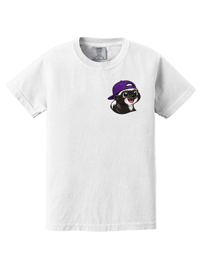 A white short-sleeve crewneck t-shirt featuring a cartoon graphic of a black and white dog wearing a purple baseball cap on the left chest, displayed against a solid white background.
