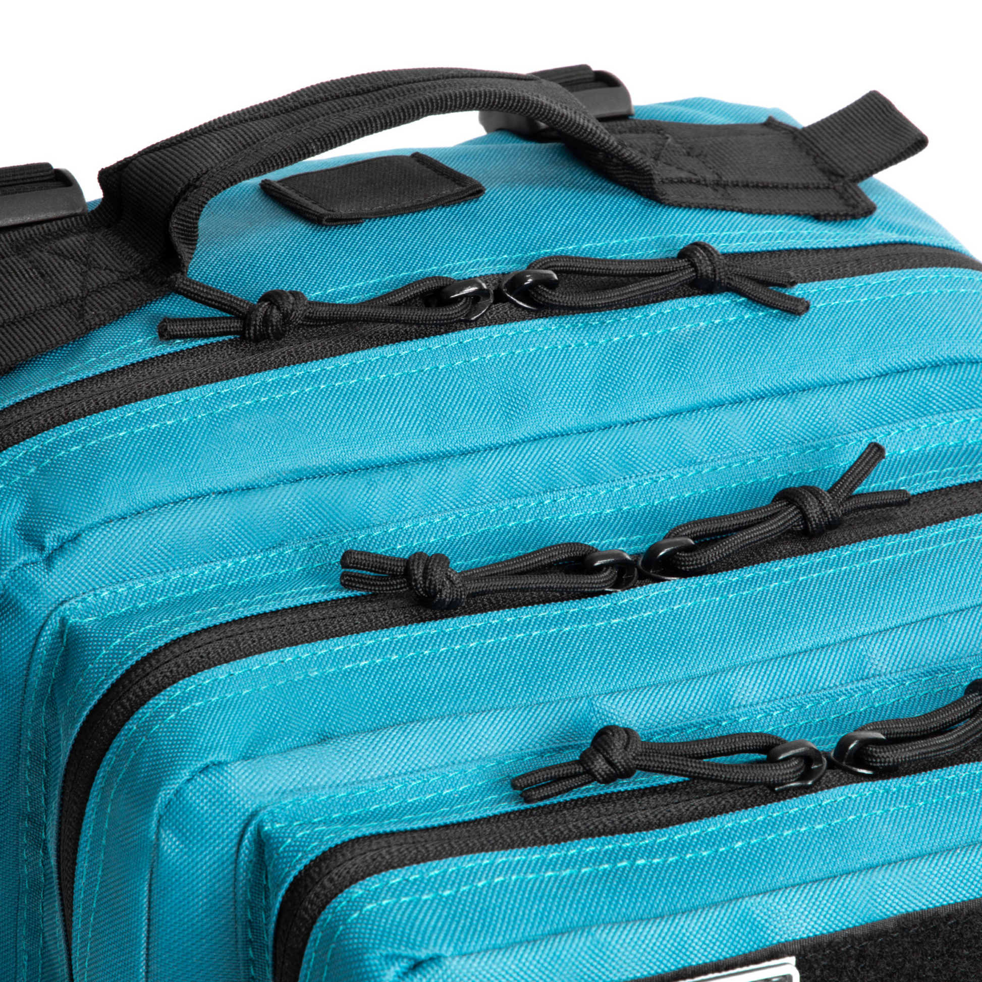 Close-up of a blue bag with black zippers and straps on a white background